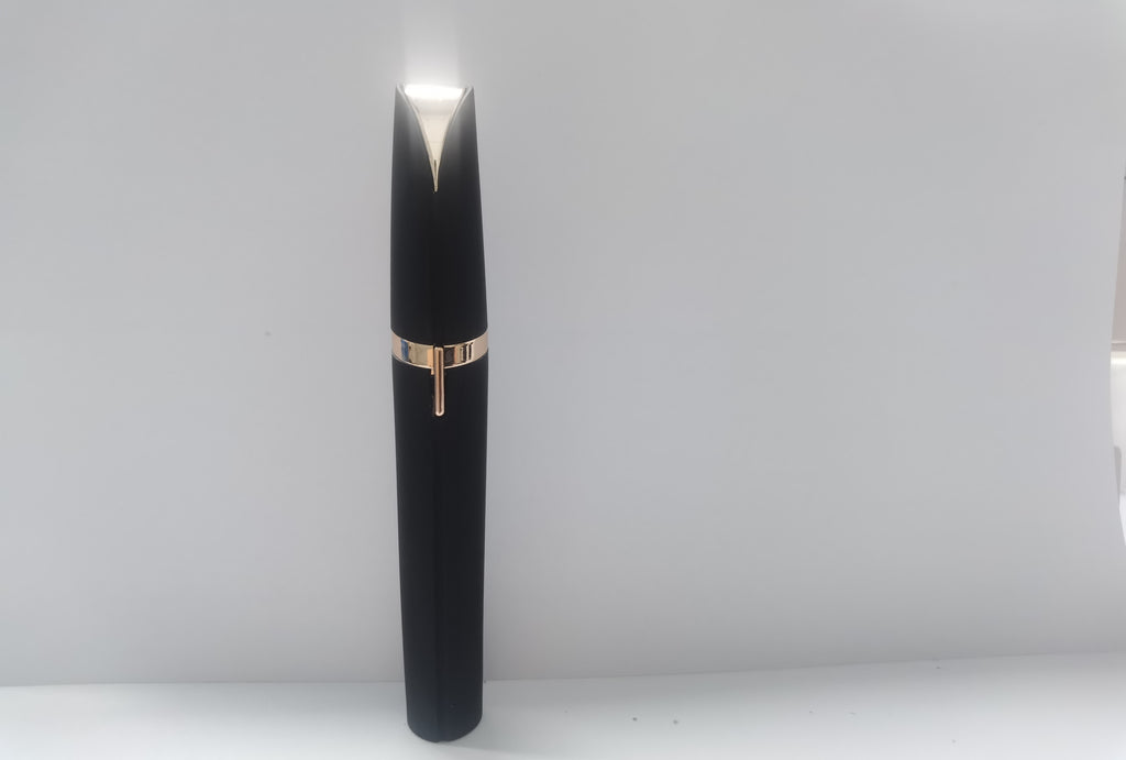 Portable eyebrow trimmer with LED light showing the compact grooming device