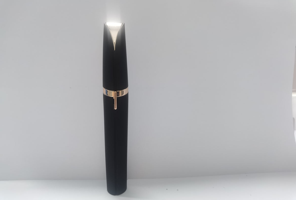 Portable eyebrow trimmer with LED light showing the compact grooming device